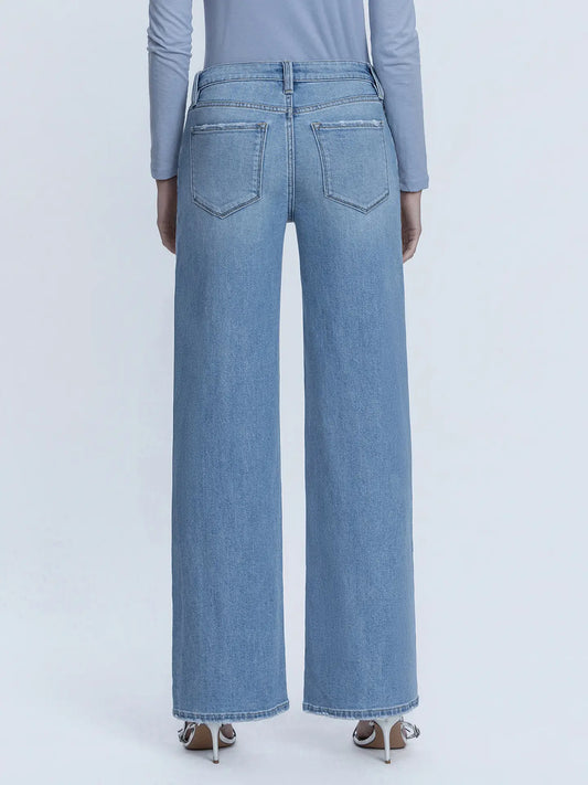 Light blue jeans worn by a person on a white background