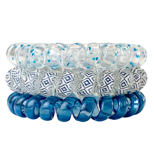 Set of blue and clear spiral hair ties with geometric patterns on a white background