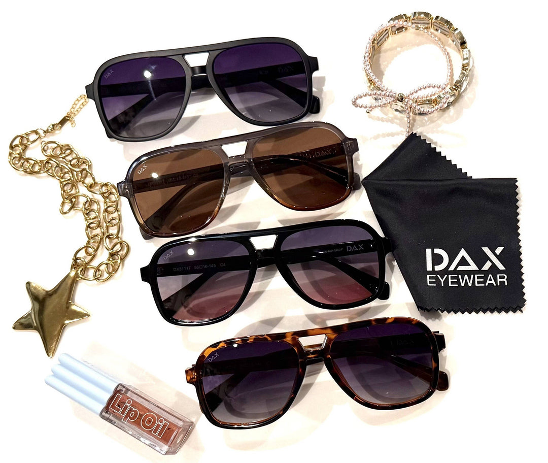 Four pairs of sunglasses with a DAX Eyewear cloth on a white background
