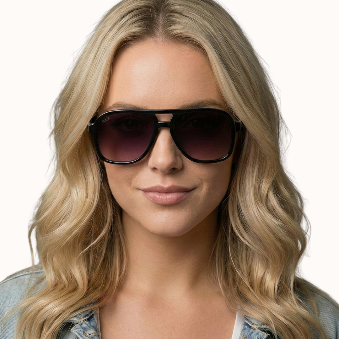 Woman wearing dark sunglasses with a neutral background