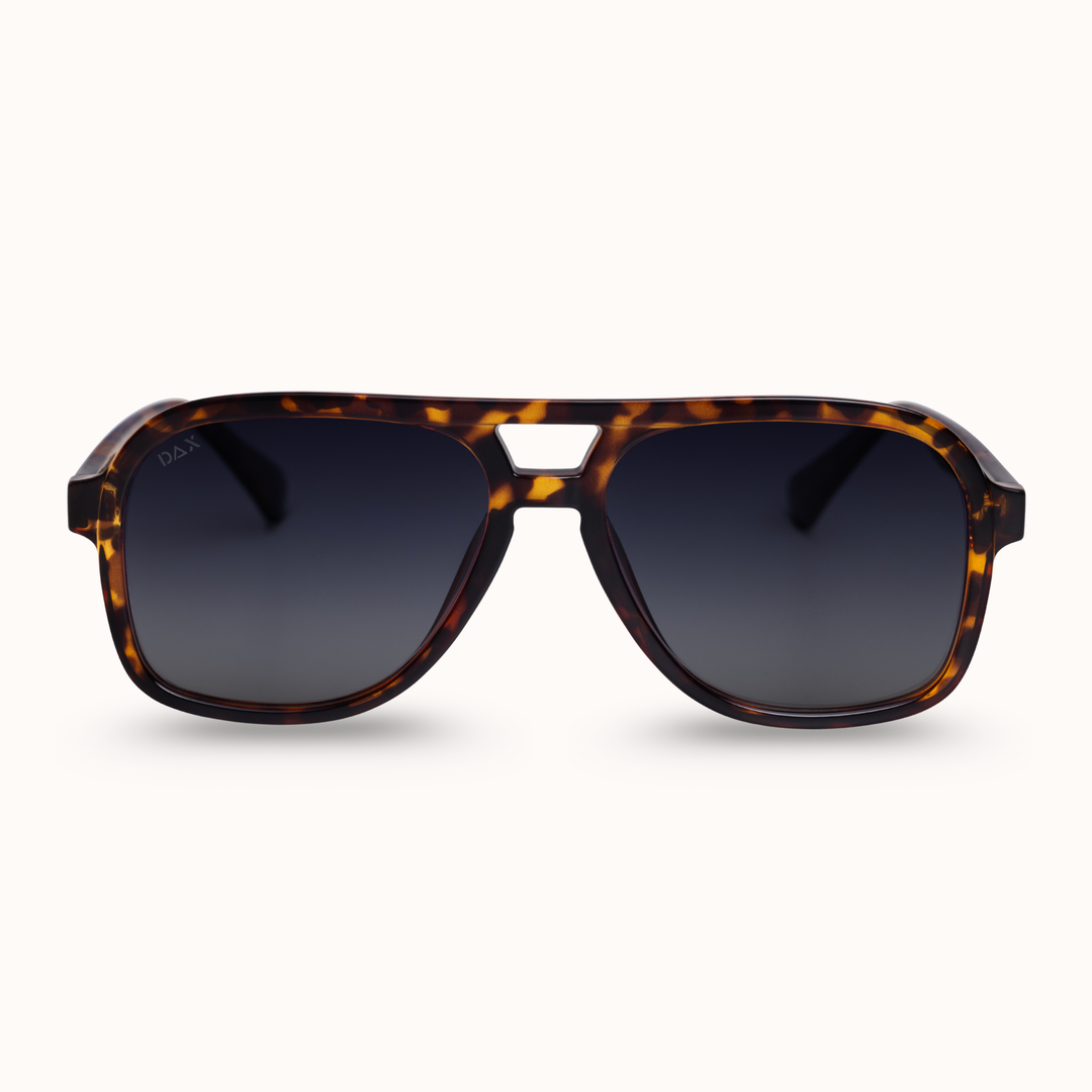 Sunglasses with tortoiseshell frame and dark lenses on a white background