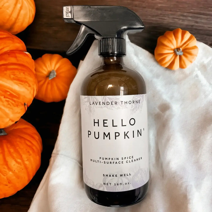 Hello Pumpkin Multi-Surface Cleaner by Lavender Thorne styled with mini pumpkins for cozy fall home cleaning.