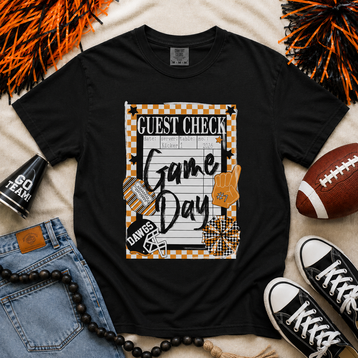 Black Comfort Colors Bulldogs game day guest check graphic tee featuring orange and black checkerboard accents, football helmet graphic, foam finger, football theme, and school spirit design.