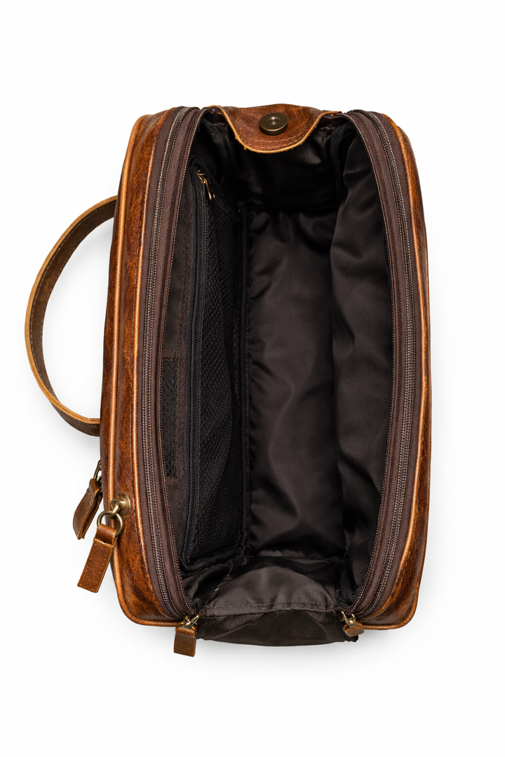 Open leather travel bag with spacious lined interior