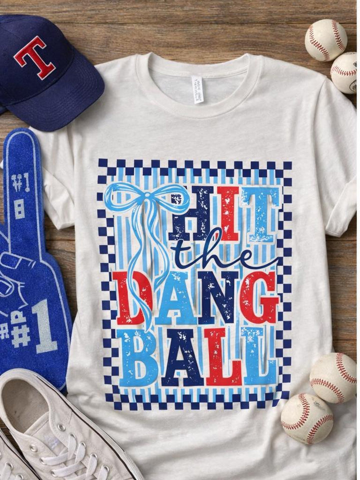 White Hit the Dang Ball baseball tee styled with sneakers, hat and baseball accessories