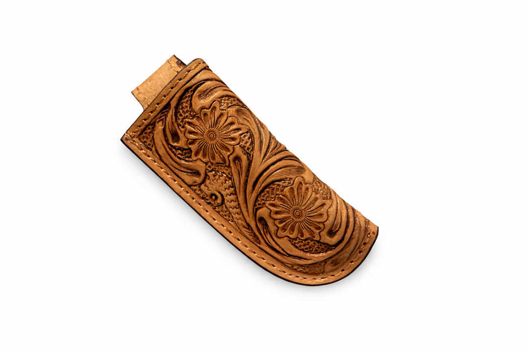 Back view of hand tooled leather knife sheath with snap belt loop closure on white background