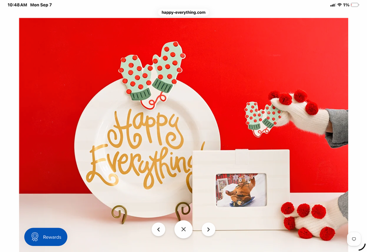 A festive holiday-themed photo display featuring a white plate with gold cursive text reading &