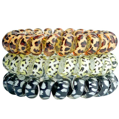 Set of three animal print patterned bracelets stacked on a white background
