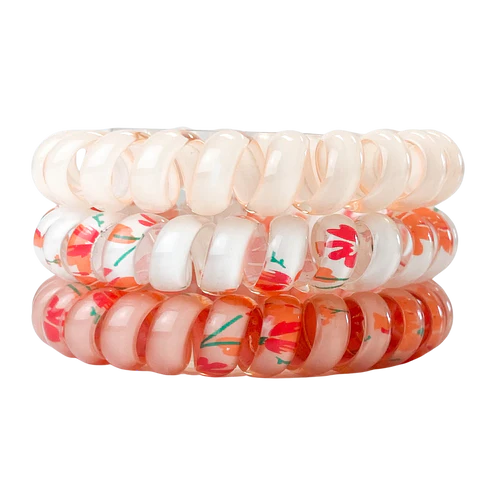 Set of three floral patterned hair ties on a white background
