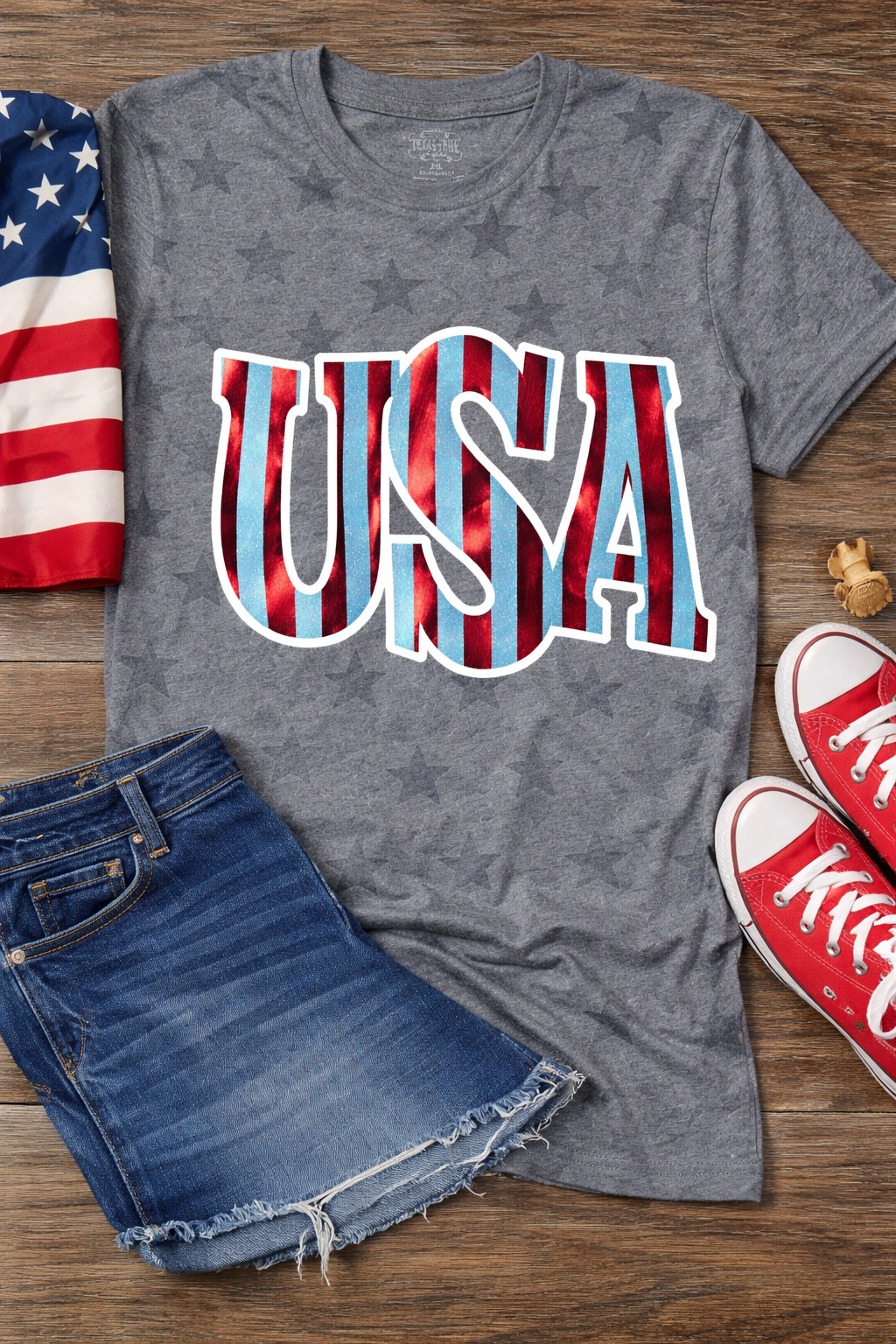 Gray patriotic USA tee with subtle star print, blue glitter lettering and red foil stripes with white outline