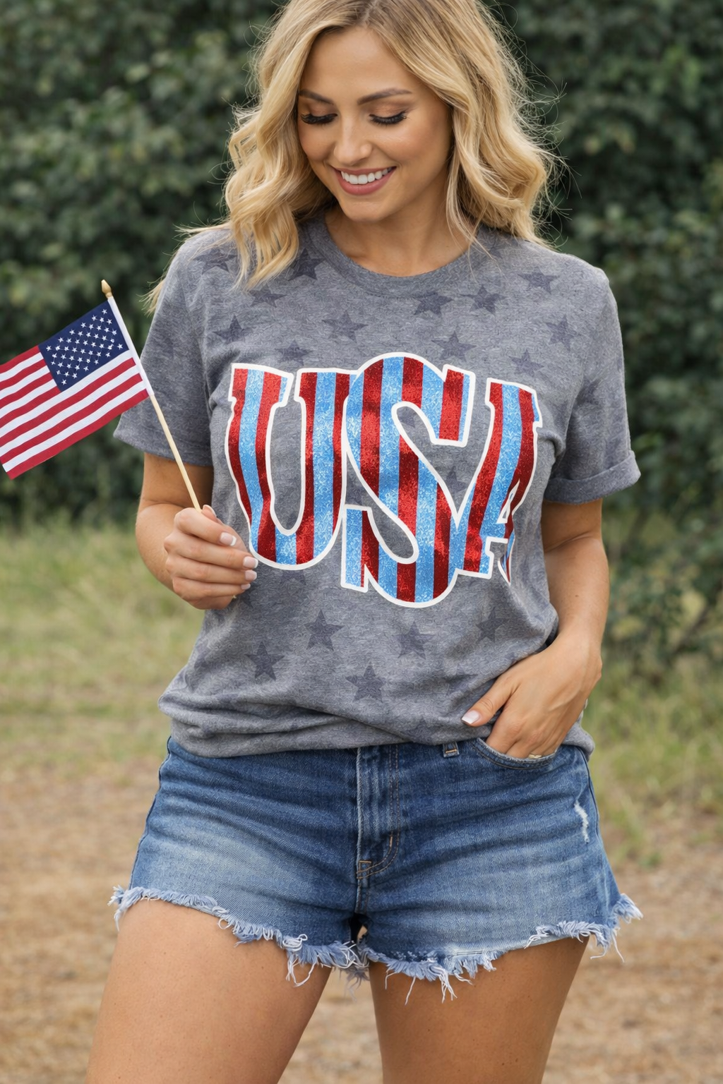 Gray patriotic USA tee with subtle star print, blue glitter lettering and red foil stripes with white outline