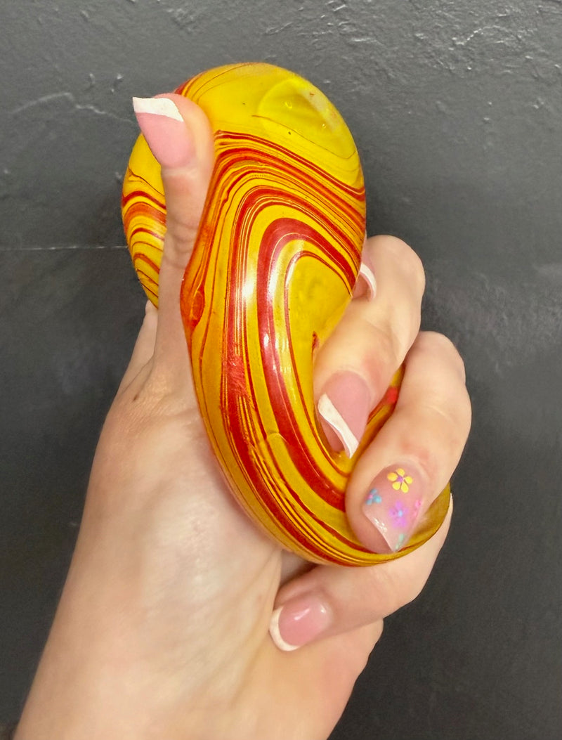 Hand holding a Yellow  Viral cube squishy