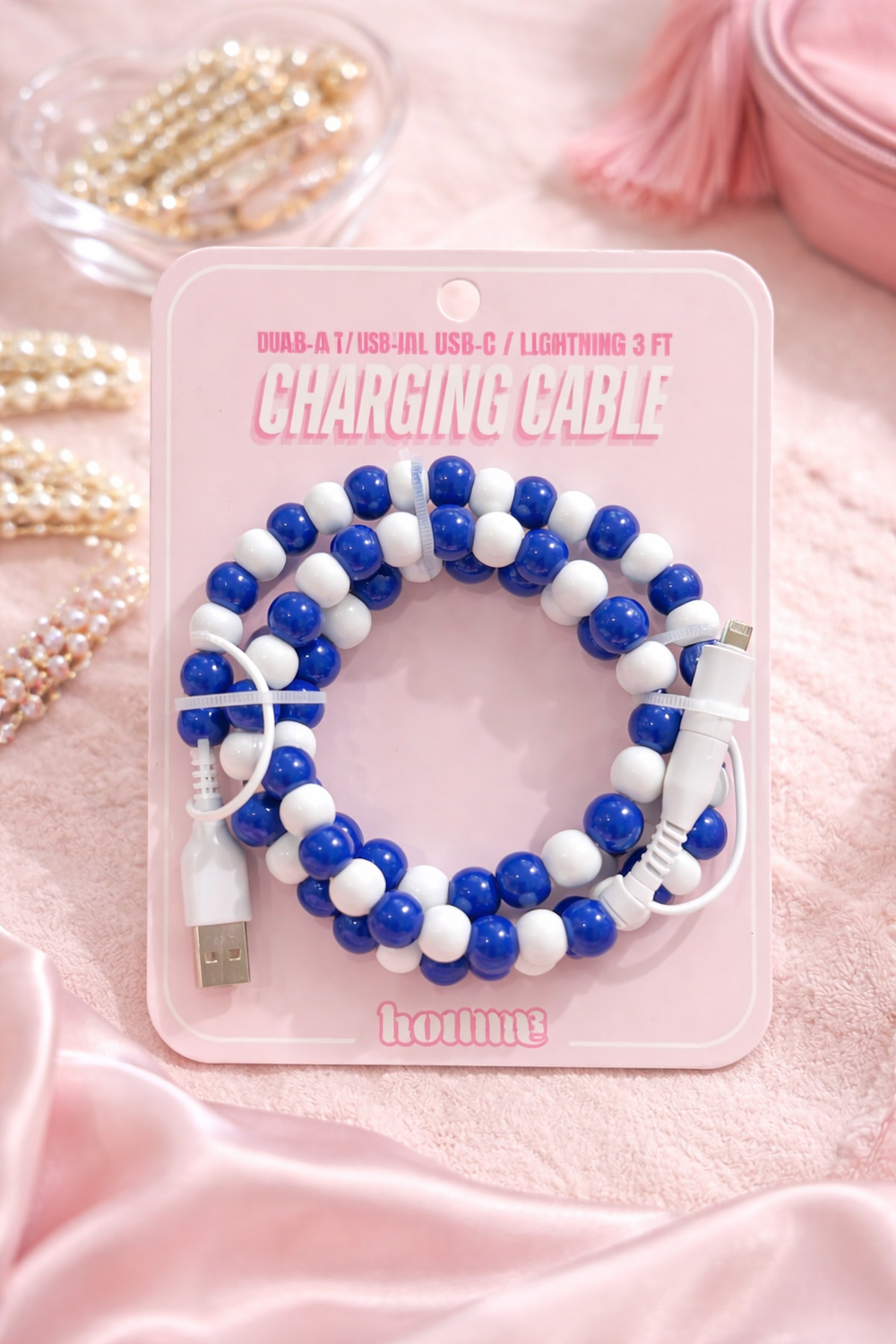 blue and white beaded phone charger cable on pink background preppy style charging cord