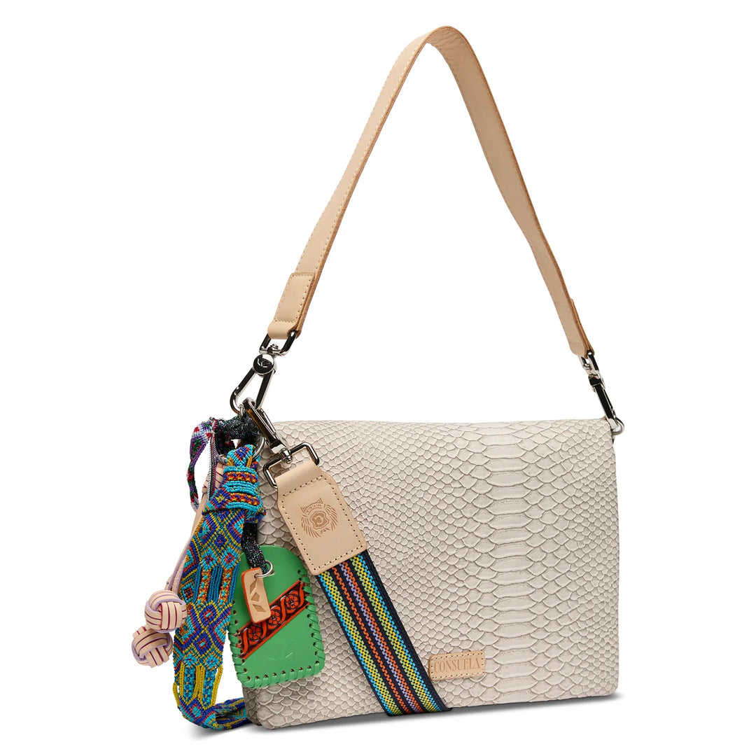 Consuela Metro Crossbody Thunderbird front view with woven strap and colorful accessories