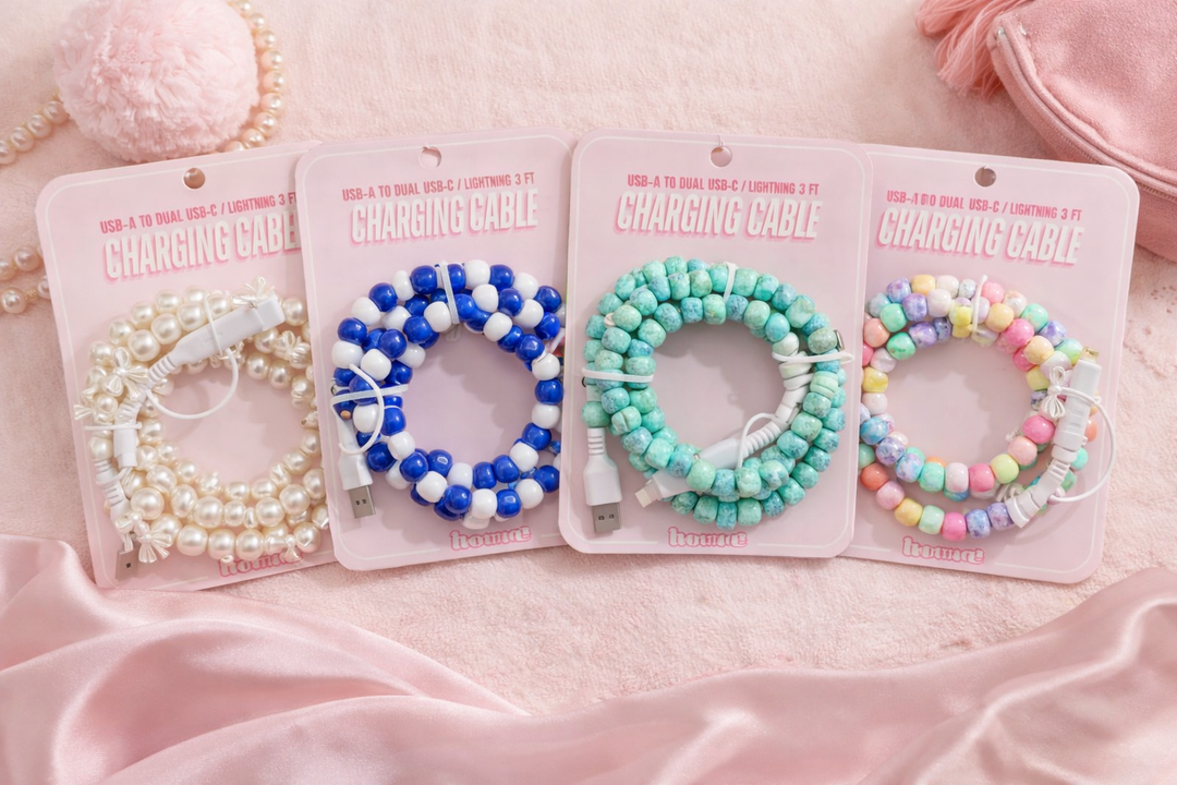 collection of cute beaded charging cables in pearl, blue white, turquoise and pastel rainbow styles on pink background