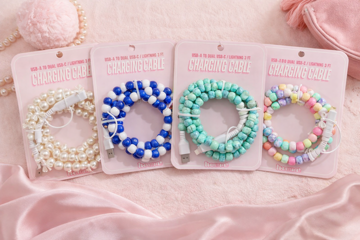 collection of cute beaded charging cables in pearl, blue white, turquoise and pastel rainbow styles on pink background