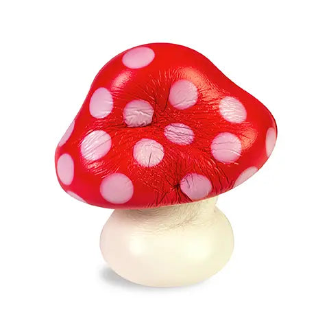 Soft red mushroom squishy with white polka dots and a cream-colored stem on a light background Squished