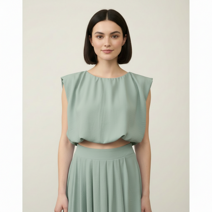 Close up of dusty mint sleeveless cropped top from two piece skirt set