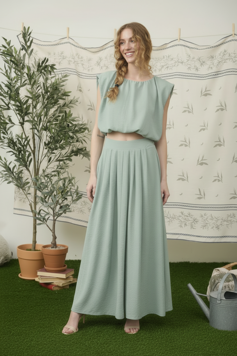  Model wearing dusty mint two piece midi skirt set with sleeveless crop top front view
