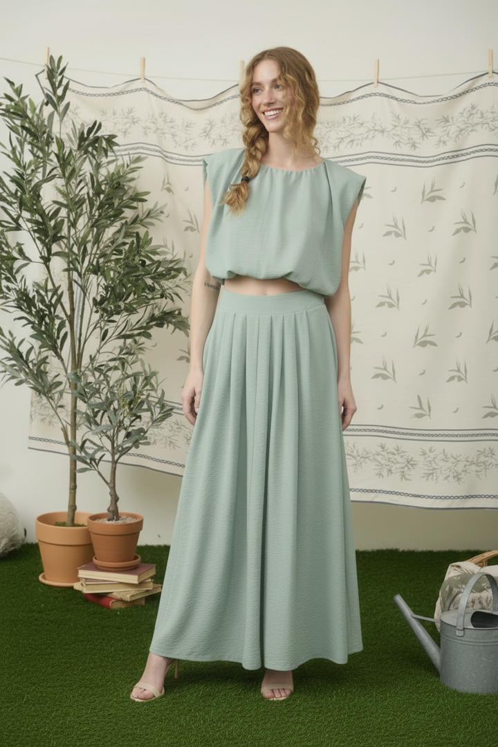  Model wearing dusty mint two piece midi skirt set with sleeveless crop top front view