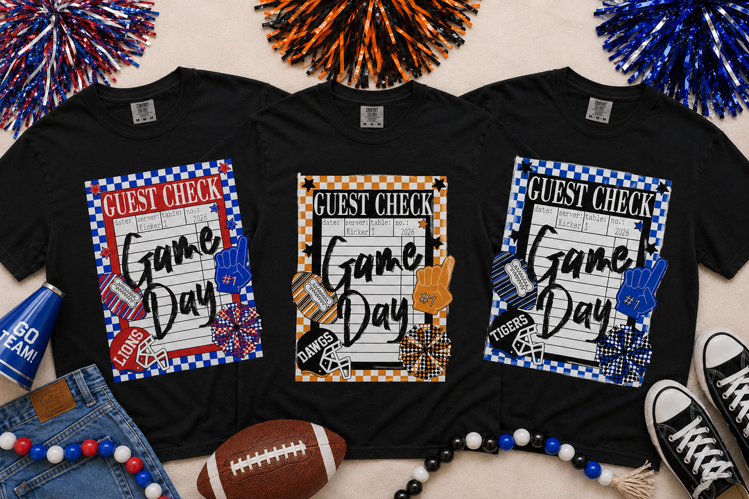 Black Comfort Colors game day guest check graphic tee featuring  school colors, checkerboard border, football helmet, foam finger, and custom spirit design.