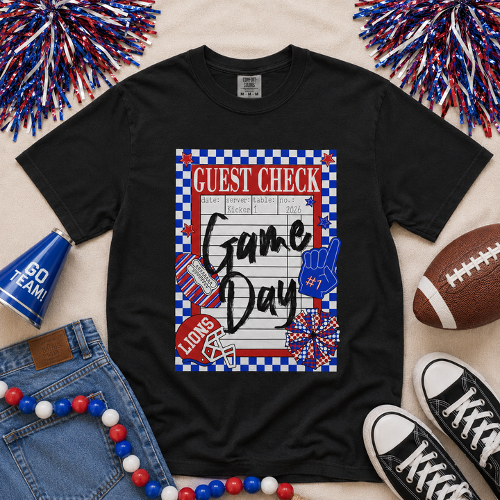 Black Comfort Colors Lions game day guest check graphic tee featuring red and royal blue school colors, checkerboard border, football helmet, foam finger, and custom Chandler Lions spirit design.