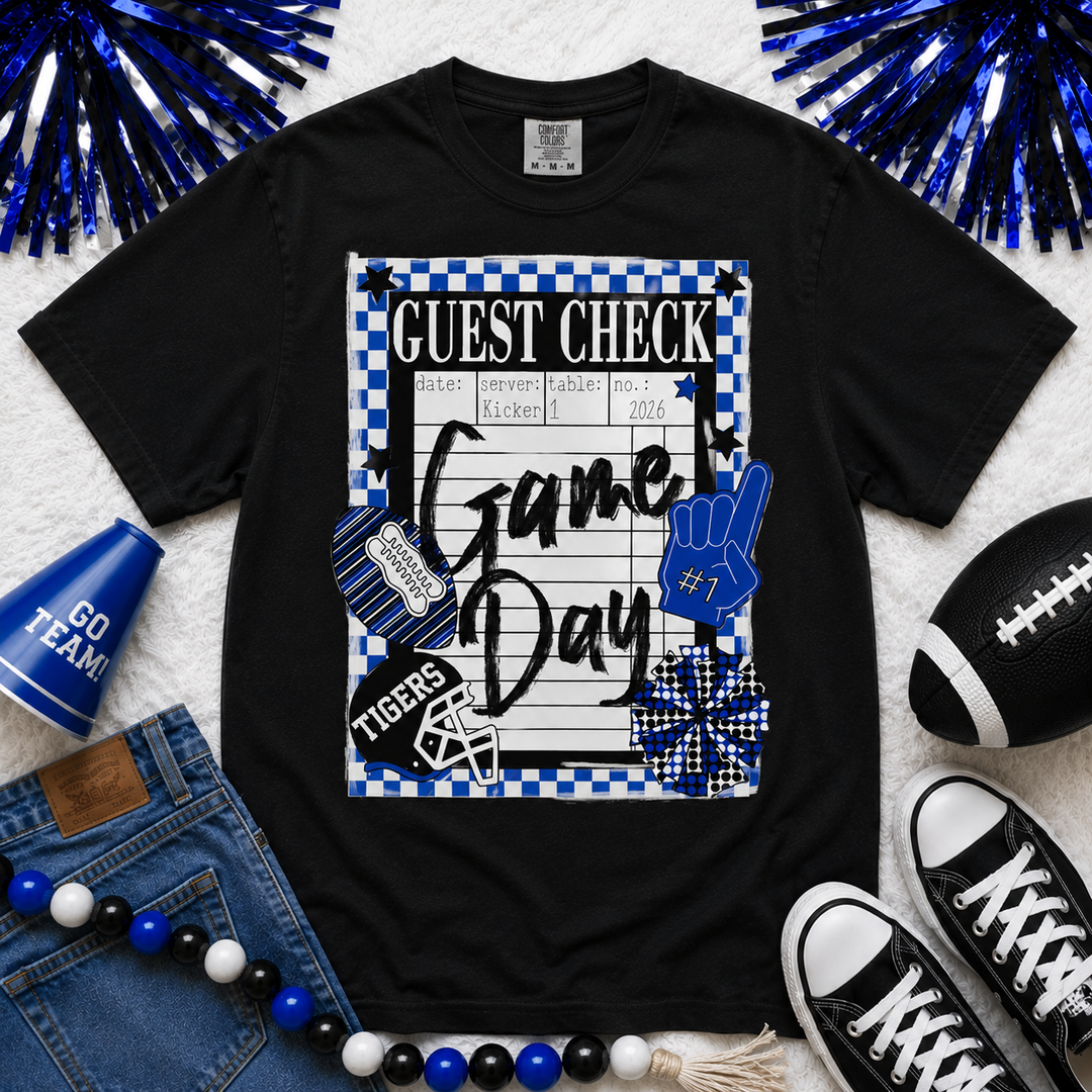 Black Comfort Colors game day guest check graphic tee featuring blue and white checkerboard accents, Tigers football helmet graphic, foam finger, football, and game day design.