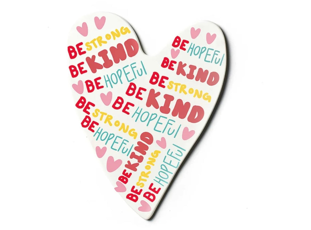 A heart-shaped white plaque or coaster featuring the words &