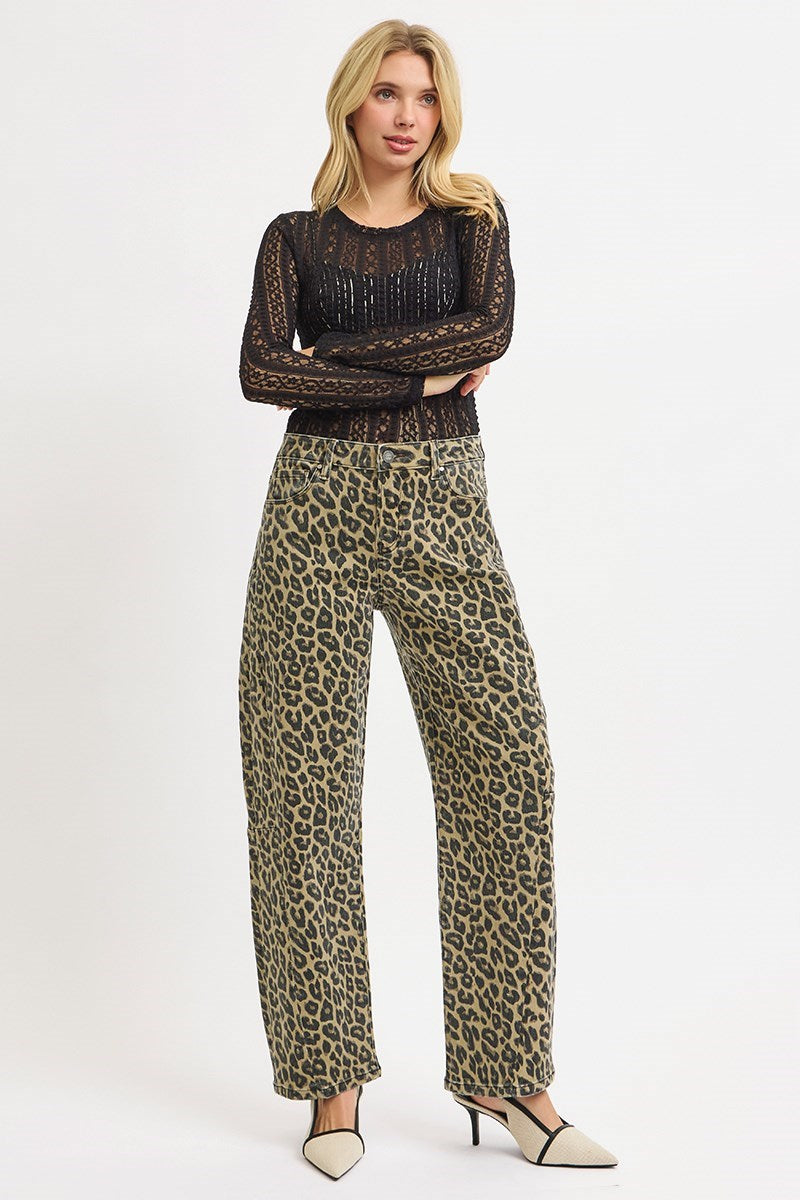 Woman wearing leopard print barrel jeans styled with black lace top and heels