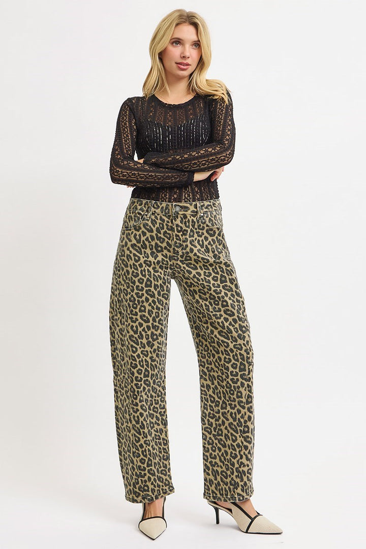 Woman wearing leopard print barrel jeans styled with black lace top and heels