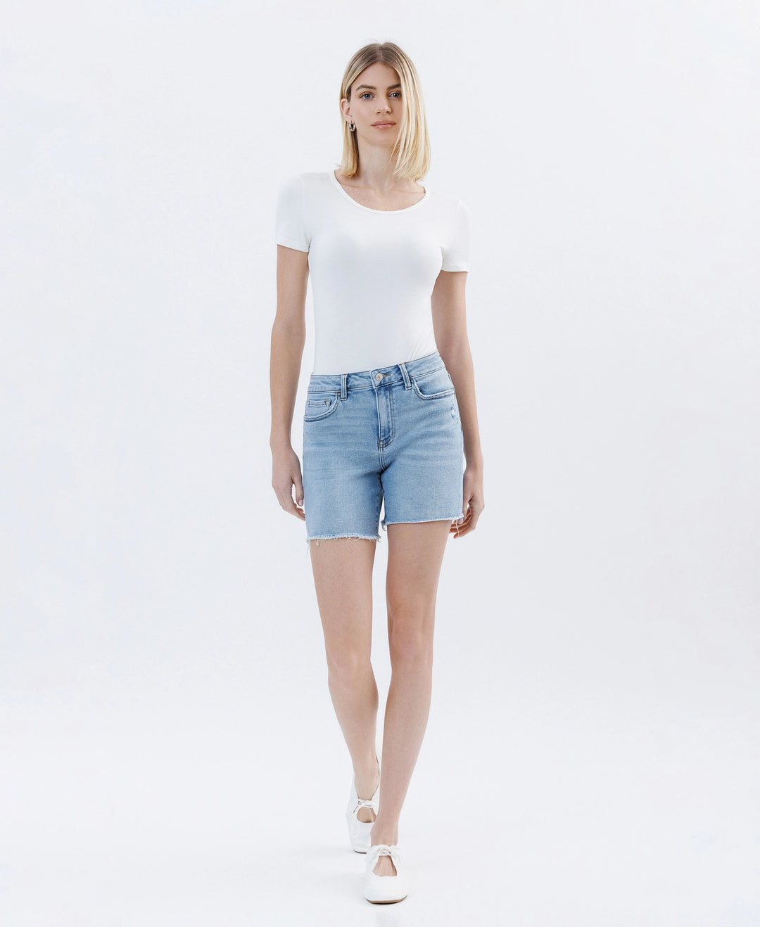 Front view of Lovervet by Vervet high rise raw hem midi denim shorts in a light wash