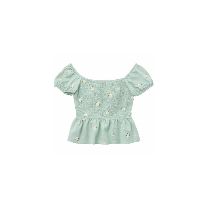 Mint green smocked off-shoulder top with white daisy embroidery and peplum hem on white background.