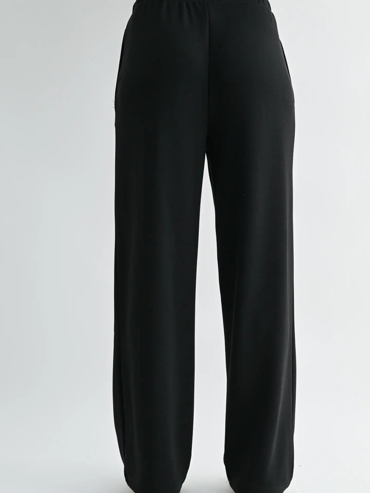 Close-up front view of Mono B Laguna Wide-Leg Pants highlighting the adjustable drawcord waistband and smooth scuba fabric finish.