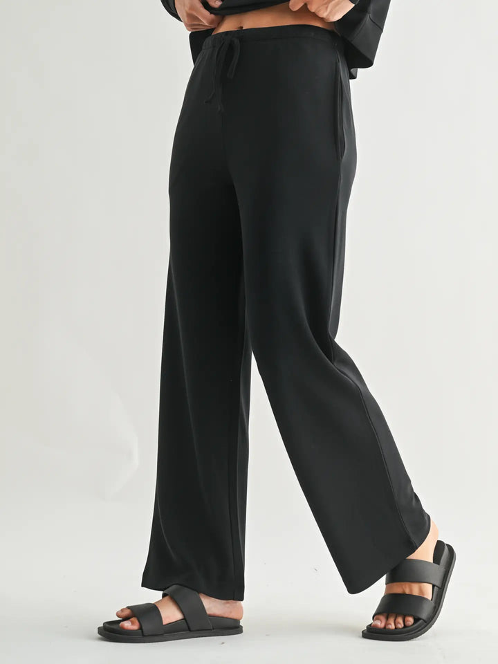 Side profile of Mono B Laguna Wide-Leg Pants showcasing the flowy fit, lightweight fabric, and relaxed design.