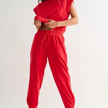 Red Mono B joggers styled casually with relaxed fit and soft French terry fabric
