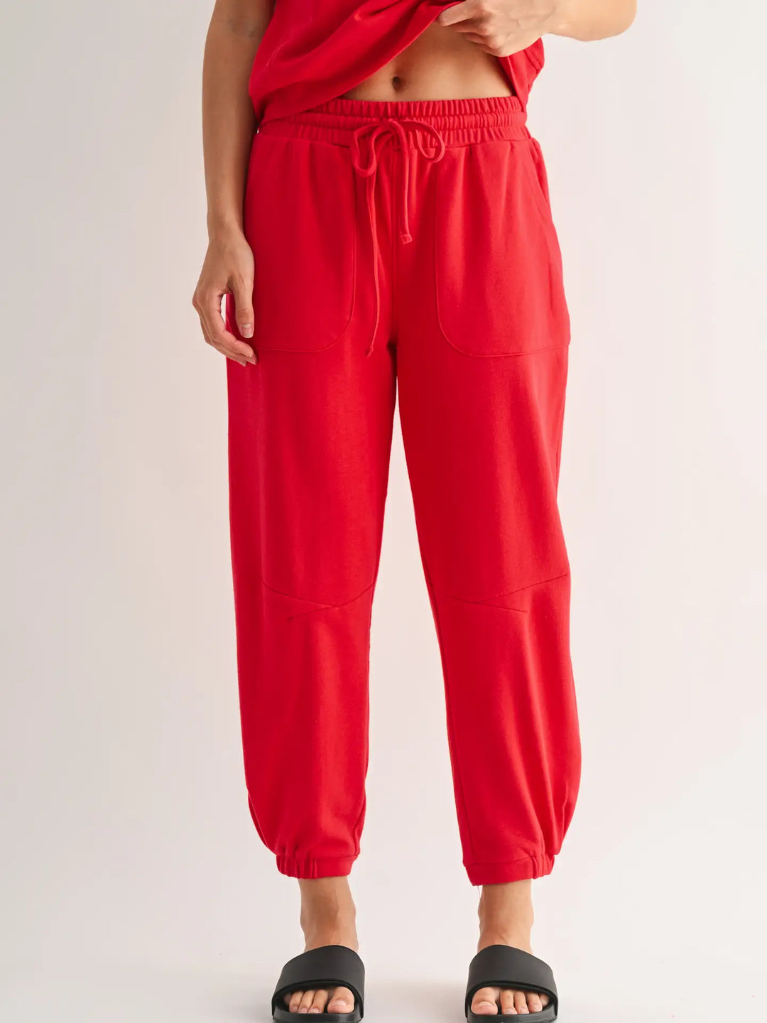Red Mono B French terry joggers front view with drawstring waist and patch pockets