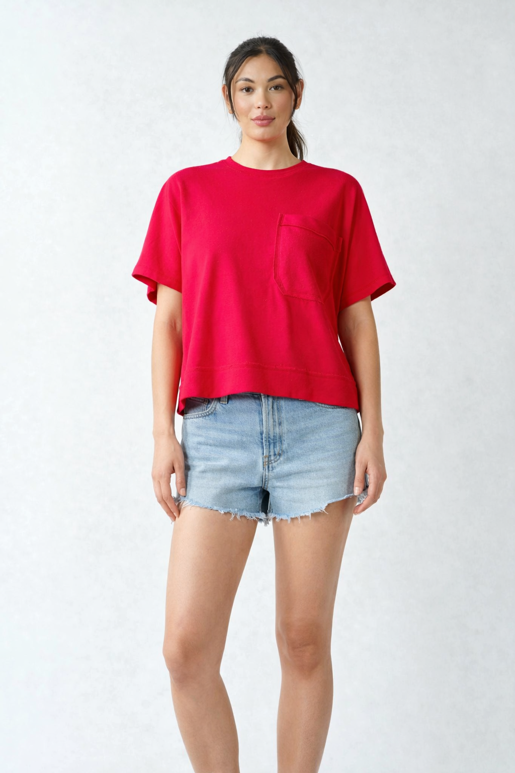 Full body view of red Mono B pocket tee with light wash denim shorts casual summer outfit