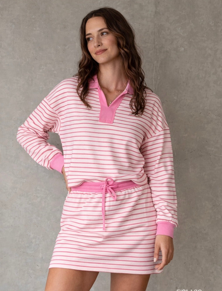 Woman wearing pink striped collared lounge set with matching skirt casual boutique outfit