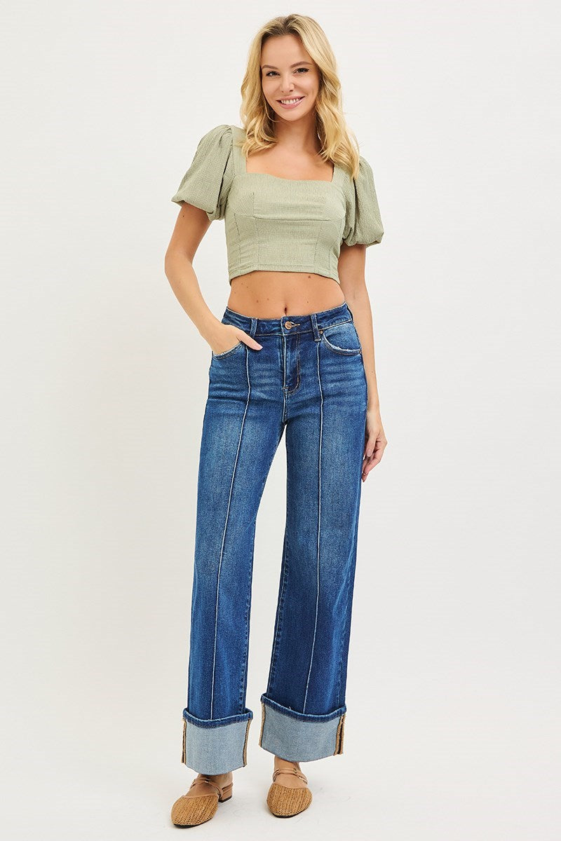Model wearing Risen High Rise Ankle Wide Turn Up Jeans featuring a flattering high-rise fit, front seam detail, and statement cuffed wide leg hem.