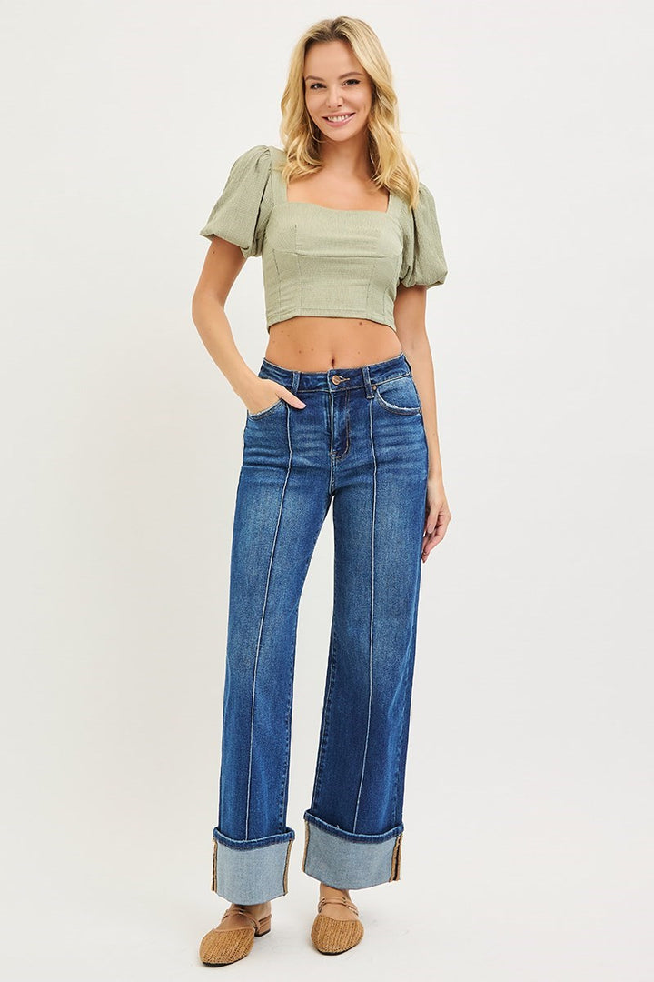 Model wearing Risen High Rise Ankle Wide Turn Up Jeans featuring a flattering high-rise fit, front seam detail, and statement cuffed wide leg hem.