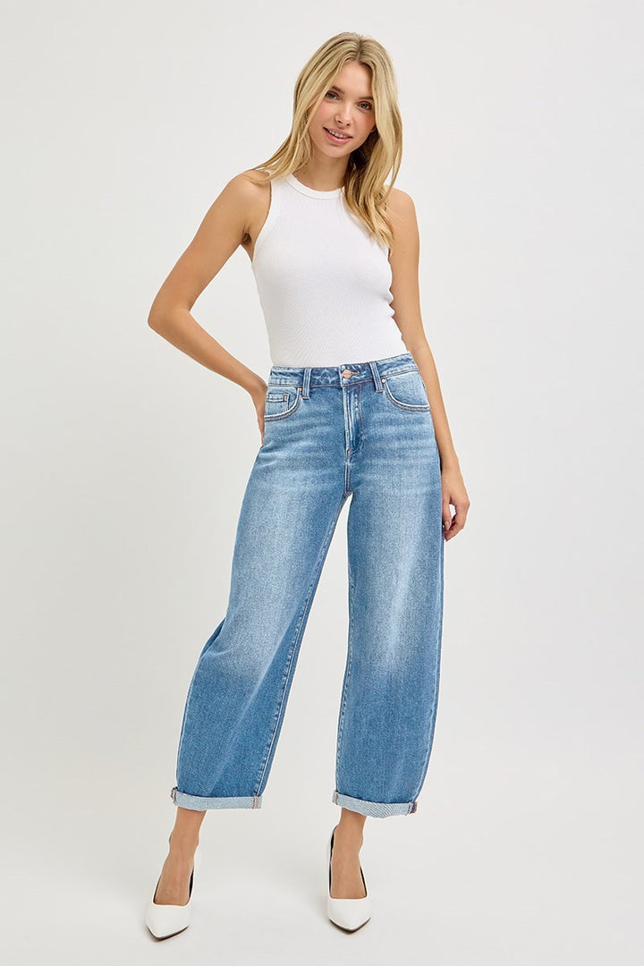 Model wearing Risen High Rise Crop Mild Barrel Jeans featuring a cropped barrel leg silhouette, light wash denim, and cuffed hem.