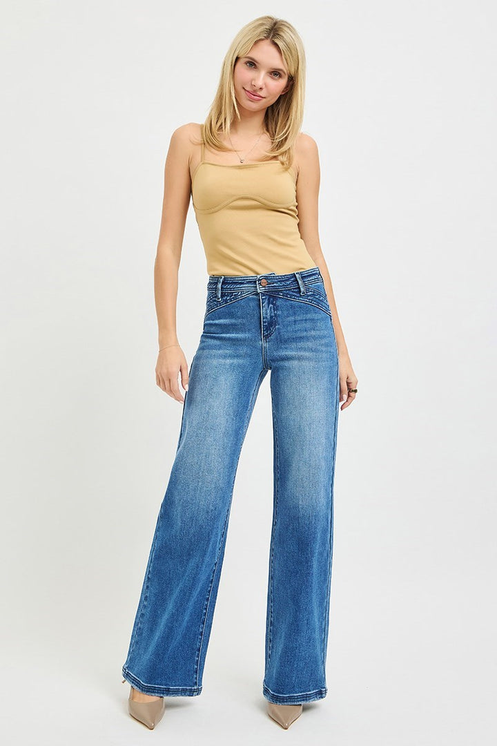 Model wearing Risen High Rise Wide Leg Waist Detail Jeans styled with a fitted tank and heels.