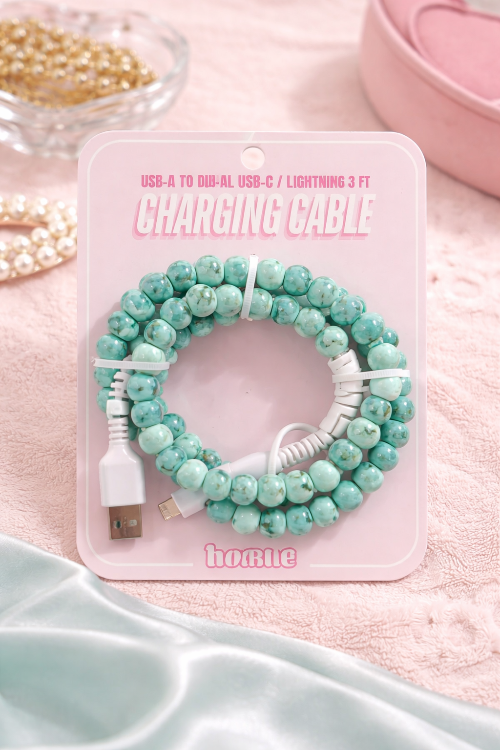 turquoise stone look beaded charging cable aesthetic phone charger on soft pink background