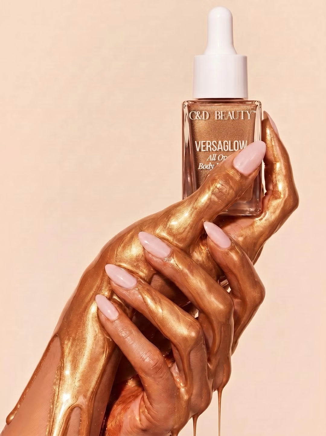 Hands coated in radiant bronze shimmer holding VersaGlow All Over Body Highlight by C&amp;D Beauty.