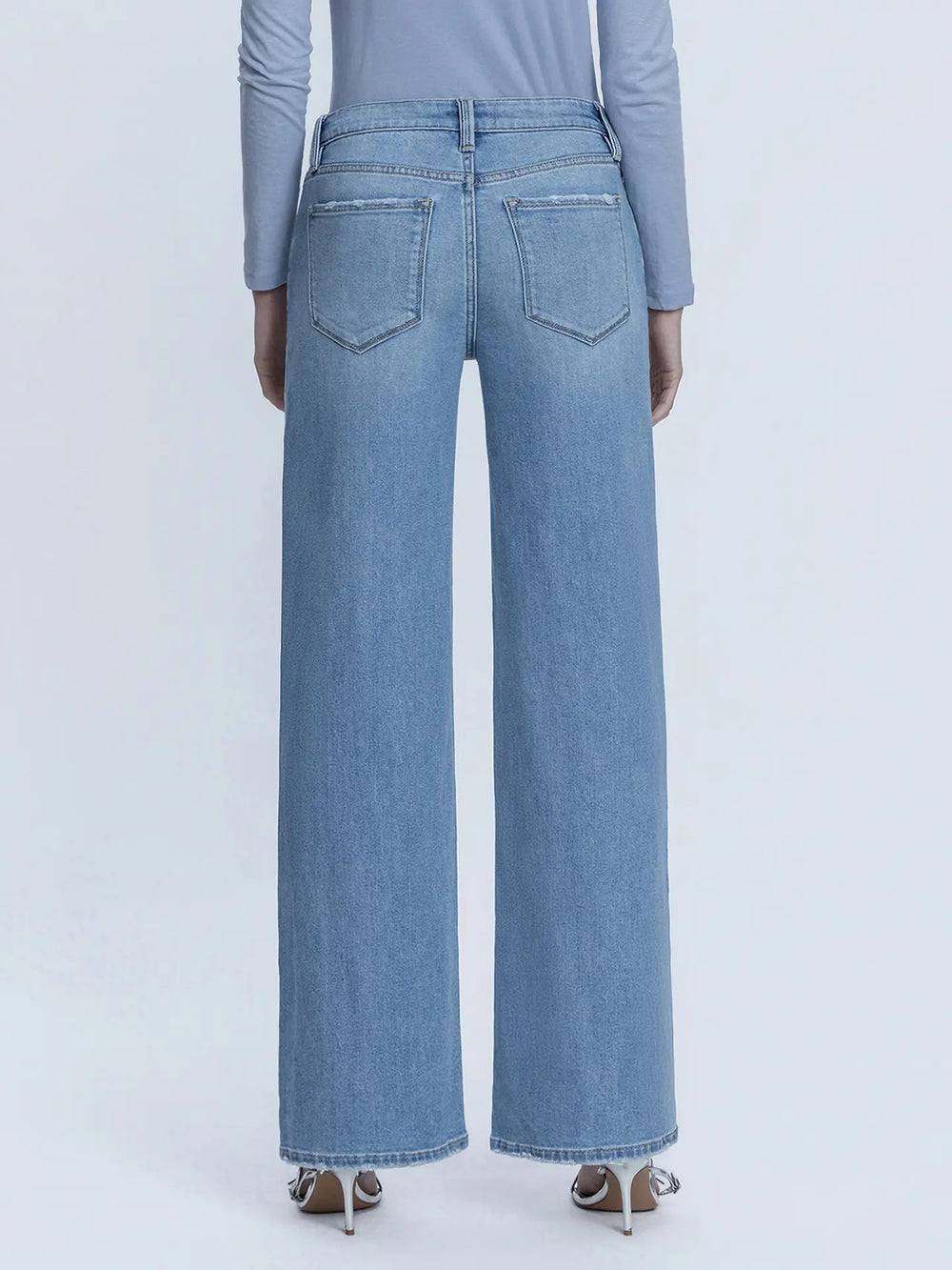 Light blue jeans worn by a person on a white background